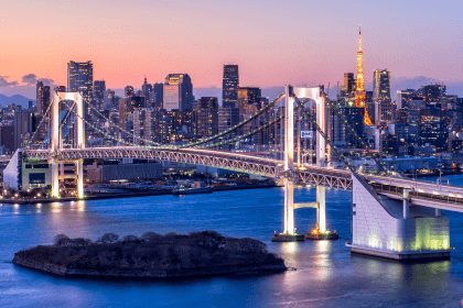 The Rainbow Bridge and Tokyo Tower at dusk.