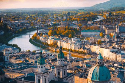 Rooftops and river of the Austrian seminar city at sunset.
